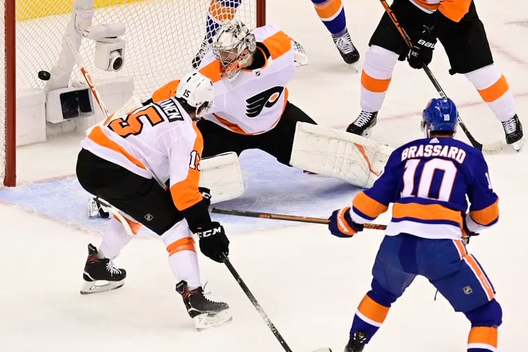 Center Derick Brassard (10), then with the New York Islanders, puts a shot past Flyers goalie Carter Hart as defenseman Matt Niskanen (15) looks on during a 2020 playoff game in Toronto. The Flyers signed Brassard on Wednesday.