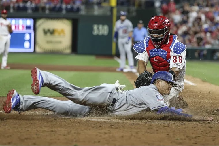 Catcher Jorge Alfaro couldn't apply the tag on the Dodgers' Manny Machado, who tied the game, 5-5, on a Max Muncy sacrifice fly in the seventh inning Monday night.