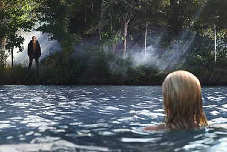 Willa Ford as Chelsea discovers Jason (Derek Mears) watching her on the lakeshore in “Friday the 13th,” the 11th gory sequel.