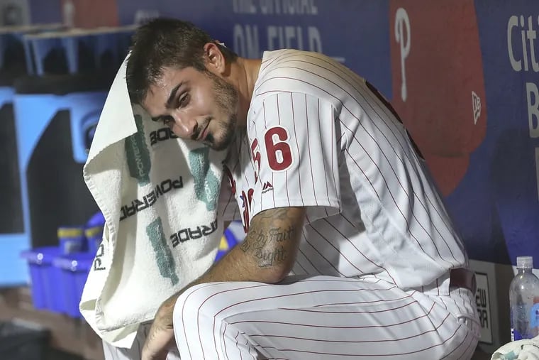 Phillies pitcher Zach Eflin wipes his head after being pulled against the Nationals.