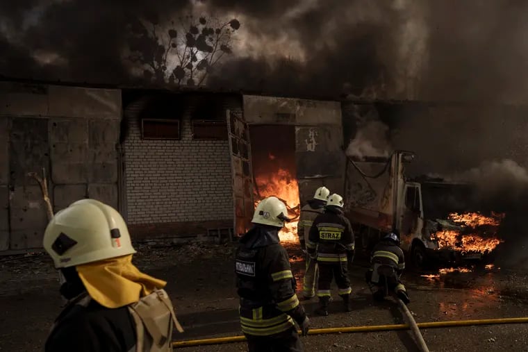 Firefighters battle a fire at a warehouse after a Russian bombardment in Kharkiv, Ukraine, Thursday, April 21, 2022.