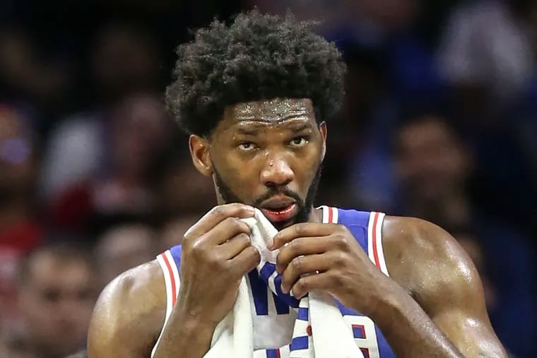 Sixers' Joel Embiid bit his lip while playing the Celtics during the 3rd quarter of the season home opener at the Wells Fargo Center in Philadelphia, Wednesday, October  23, 2019. Sixers beat the Celtics 107-93.