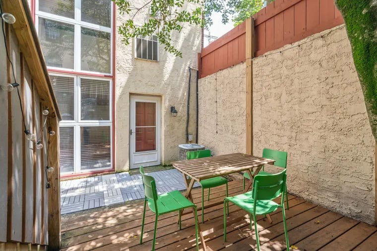 The home has a private patio with a shade tree.