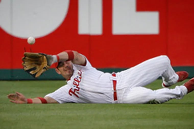 Phillies centerfielder Aaron Rowand can&#0039;t get a ball hit by Washington&#0039;s Austin Kearns in the second inning of last night&#0039;s game. Kearns made it to third base.