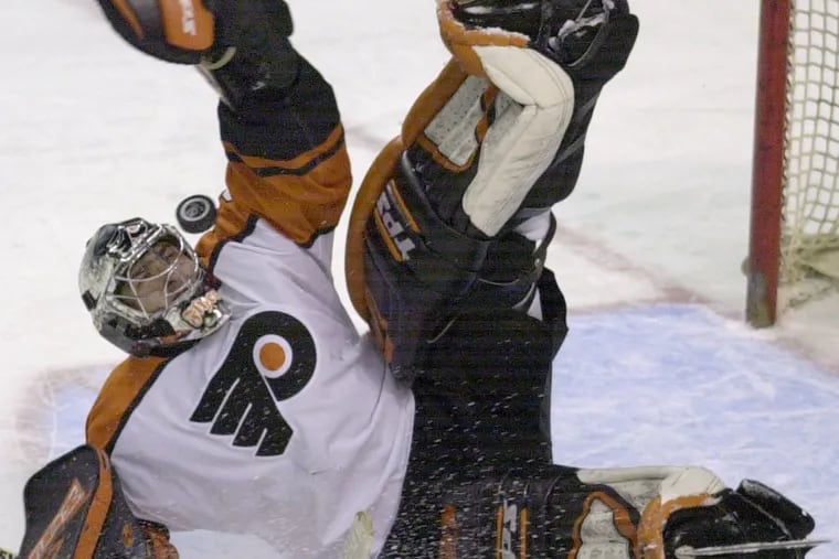 Former Philadelphia Flyers goalie Roman Cechmanek makes a save on a breakaway by Atlanta Thrashers' Brad Tapper, not shown, during the 2003 season.