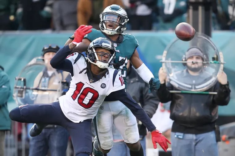 Rasul Douglas (behind) breaks up a pass intended for Texans receiver DeAndre Hopkins.