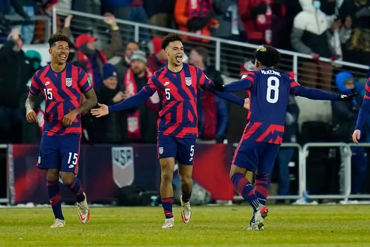 United States' Antonee Robinson (5) celebrates his goal with Weston McKennie (8) and Chris Richards (15) during the second half of a FIFA World Cup qualifying soccer match against El Salvador, Thursday, Jan. 27, 2022, in Columbus, Ohio. (AP Photo/Julio Cortez)