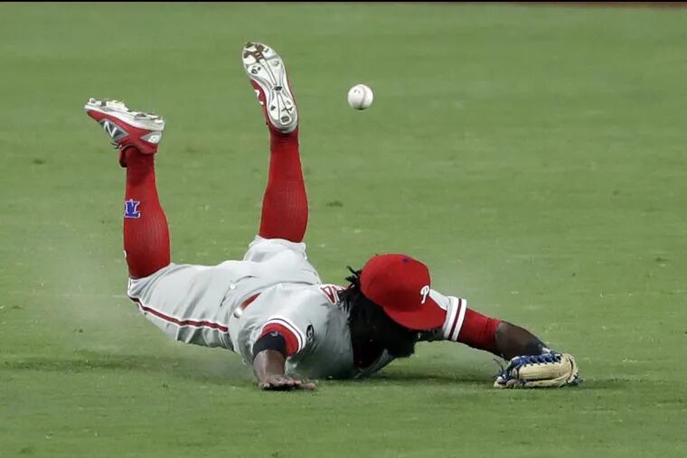 Phillies centerfielder Odubel Herrera can’t reach an RBI single by San Diego’s Austin Hedges during the sixth inning Monday.