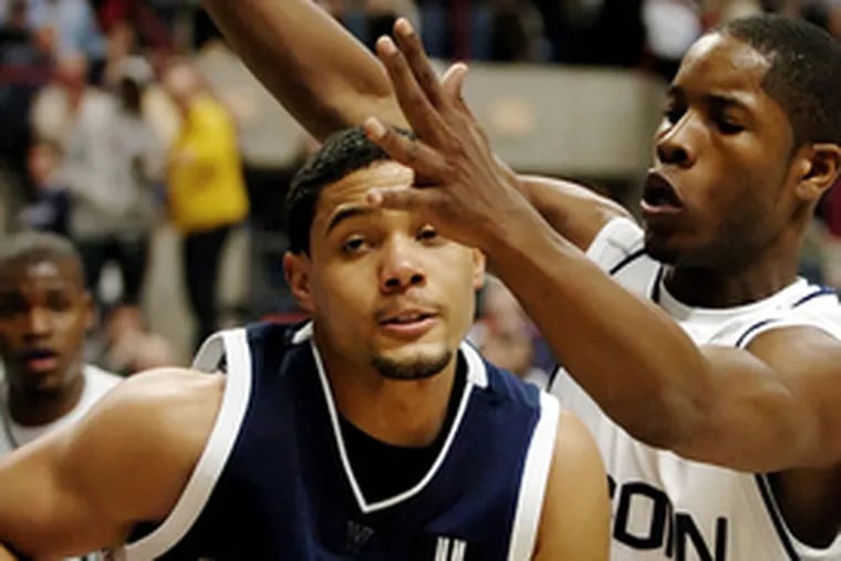 Villanova guard Scottie Reynolds moves around UConn&#0039;s Jerome Dyson during the first half. Reynolds&#0039; 40 points - more than half of the team&#0039;s total - broke a freshman school record set in 1978. But his fouling out, he said after the game, encouraged by coach Jay Wright, was &quot;kind of stupid.&quot;