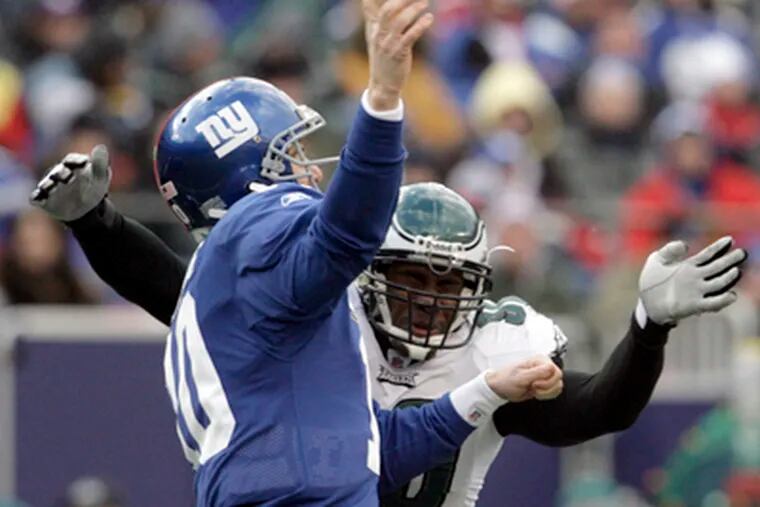 Eagles&#0039; Darren Howard attacks Giants QB Eli Manning.