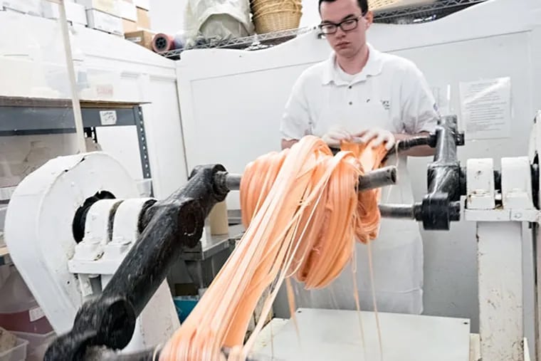 Joshua Yarger pulls a new batch of salt water taffy at Shriver’s in Ocean City, N.J. (ED HILLE / Staff Photographer)