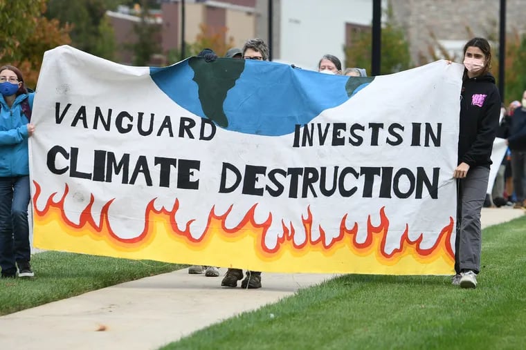 Demonstrators gather at the main entrance to the Vanguard campus in Malvern on Oct. 29, 2021, to pressure the company to take action in addressing climate change.
