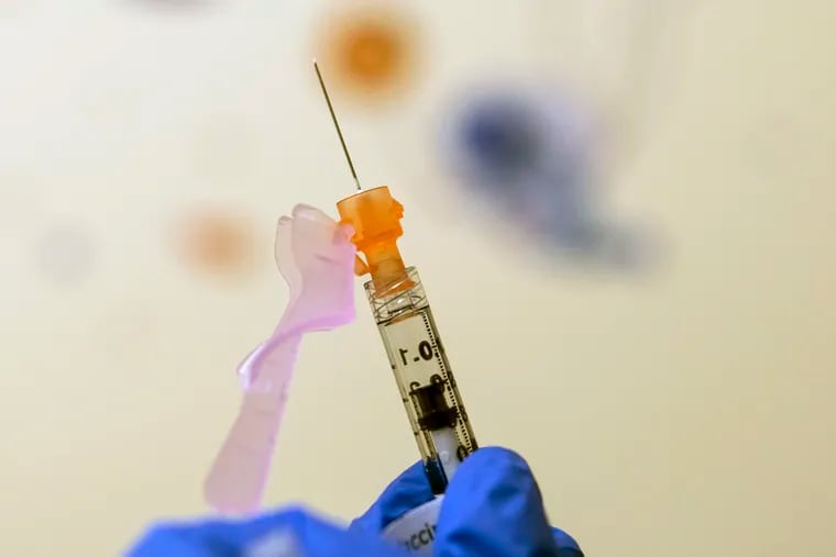 A nurse prepares a child's COVID-19 vaccine dose at Children's National Hospital in Washington.