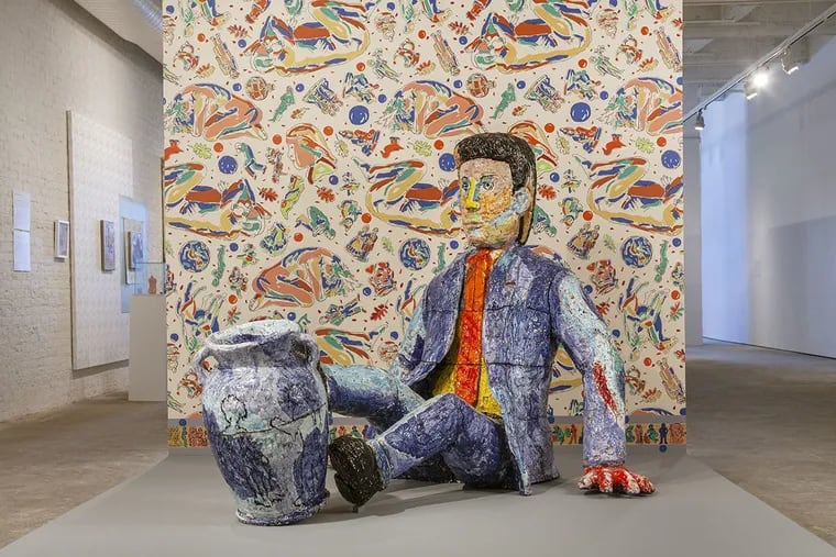 Viola Frey's "Man Balancing Urn" (2004) and, in background, Artist's Mind/Studio/World (1992), designed in conjunction with Fabric Workshop and Museum