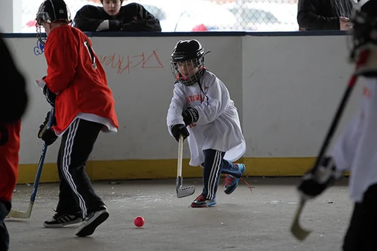 Bobby "Boo" Markley, 8, passes to a teammate during a youth hockey league match at the Fishtown Rec Center Rink in Philadelphia, Pa. on February 9, 2014. ( DAVID MAIALETTI / Staff Photographer )