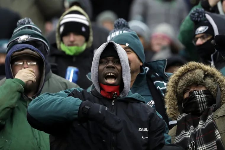Bundled fans at Eagles-Cowboys game on Dec. 31; it won’t be quite as frigid Saturday, but it will be cold.