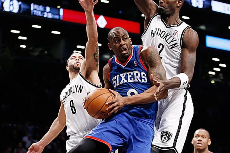 Nets guard Deron Williams and forward Kevin Garnett defend 76ers guard James Anderson. (Kathy Willens/AP)