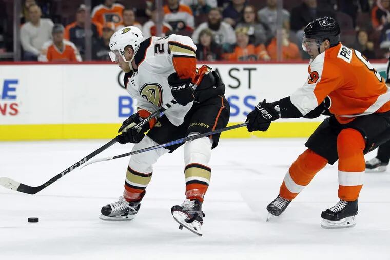 The Ducks' Ondrej Kase, left, is hooked by the Flyers' Ivan Provorov on a breakaway that resulted in a penalty shot and goal Tuesday.