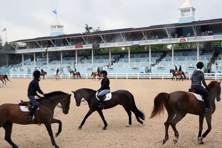 Horses and riders warm up for the 2014 Devon Horse Show. (CLEM MURRAY / Staff Photographer)
