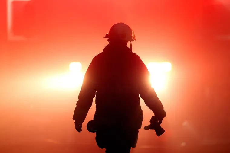 A firefighter walks through smoke from a fire in this file photo. (AP)