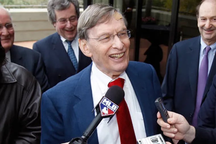 Commissioner Bud Selig, center, answers reporters' questions following a meeting with team owners, Thursday, Jan. 12, 2012, in Paradise Valley, Ariz. Selig has been given a two-year contract extension through the 2014 season. (AP Photo/Paul Connors)