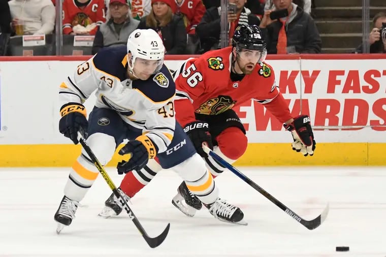 Buffalo Sabres left winger Conor Sheary and Chicago Blackhawks defenseman Erik Gustafsson (56) going for the puck during a game on Nov. 17, 2019. Gustafsson, who finished the season with Calgary, was signed by the Flyers on Monday.