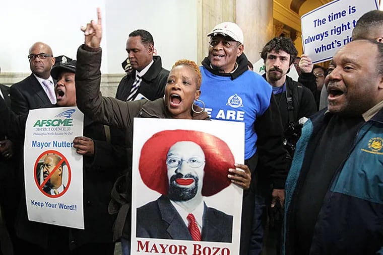 March 2013 file photo: Protesters celebrate in the 4th-floor hallway of City Hall after their disruptions forced Mayor Nutter to cancel his budget address to City Council. Kim Athanasiadis, President of Local 488, is center.  (CHARLES FOX / Staff Photographer)