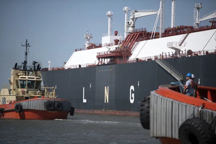 Tug boats pull out an LNG tanker vessel at the facility in Louisiana. Chester residents and the bankruptcy official hold that Chester's long-term economy would fare better without an LNG plant.