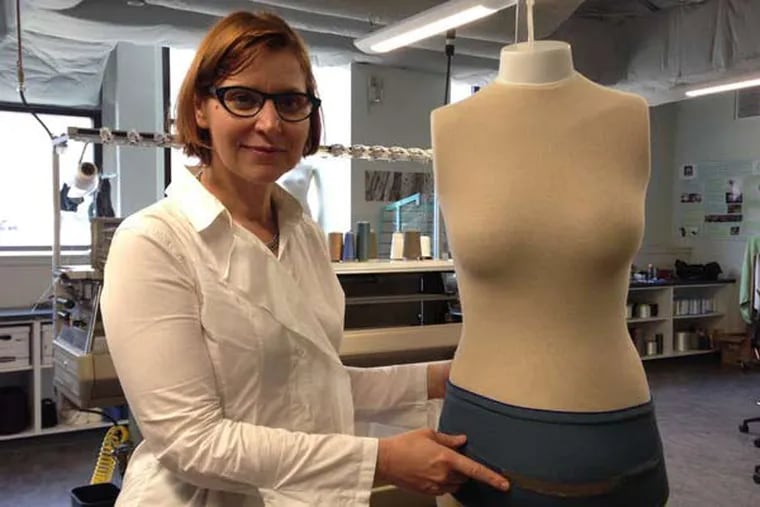 Genevieve Dion, a fashion designer and director of Drexel's Shima Seiki Haute lab, shows off a belly band with built-in fetal monitor. MEERI KIM