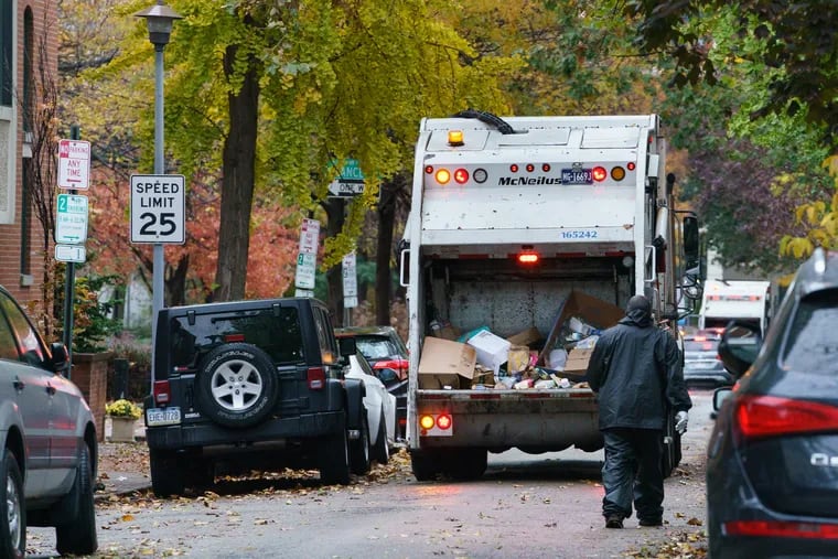 A trash truck proceeds down the street, in Philadelphia, November 12, 2019.