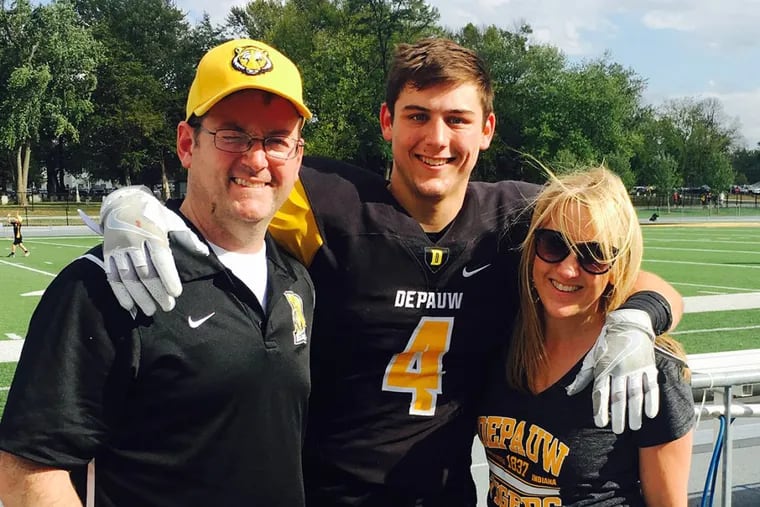 Hunter Sego is flanked by his parents, Bryon and Kathy Sego, at a DePauw University football game this fall. Hunter, who is a punter and plays safety, has Type 1 diabetes. He needs four vials of insulin a month, and the price recently jumped to $487 each.