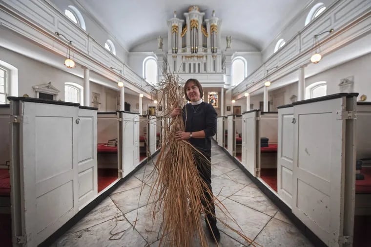 Rev. Claire Nevin-Field holds the ornamental grass that members of St. Peter’s Episcopal Church in Society Hill will wave on Palm Sunday.