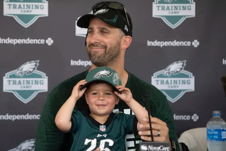 Eagles coach Nick Sirianni speaks to the media joined by  his son Miles during training camp on Thursday.