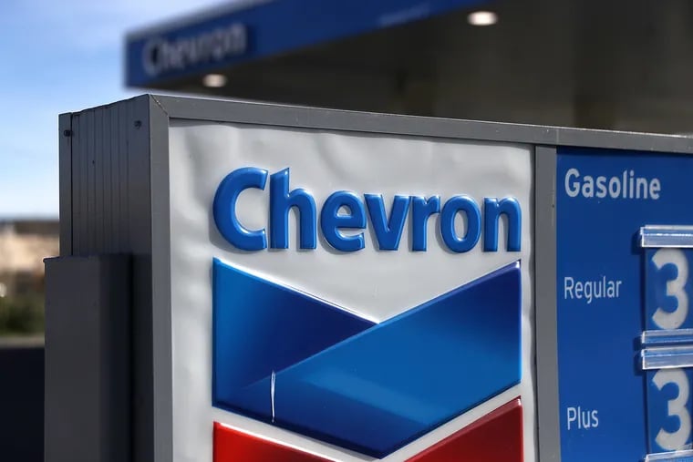 A sign is posted in front of a Chevron gas station on Feb. 2, 2018, in Corte Madera, California. The Biden administration has granted Chevron a license to resume oil production in Venezuela.