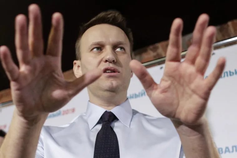 FILE – In this file photo taken on Saturday, Feb. 4, 2017, Russian opposition leader Alexei Navalny gestures at a news conference in his campaign office in St. Petersburg, Russia.