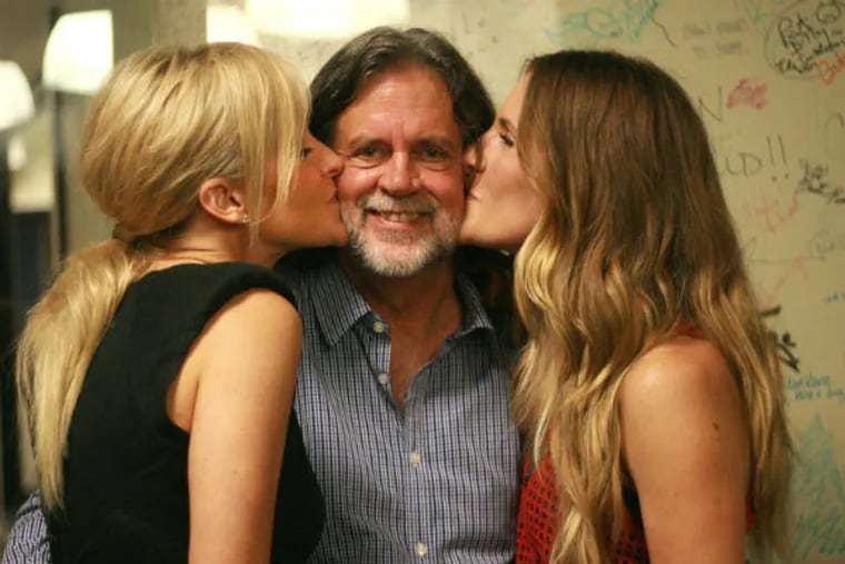 Roger LaMay enjoys a job perk: getting kissed by Dixie Chicks/Court Yard Hounds sisters Martie Maguire (left) and Emily Robison.