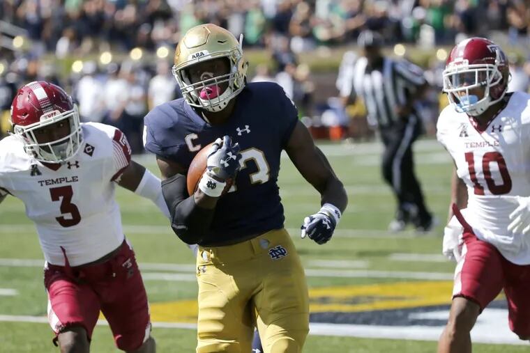 Notre Dame running back Josh Adams (center) sprints to the end zone for a touchdown past Temple defensive back Sean Chandler (3) and Mike Jones (10) during the first half of Saturday’s action.