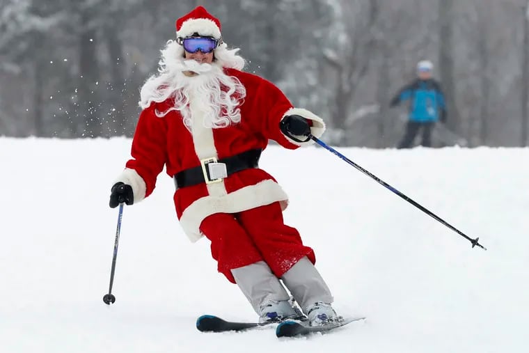 A skier dressed as Santa Claus heads downhill during the annual Santa Sunday event, Sunday, Dec. 2, 2018, in Newry, Maine. The red-suited lookalikes aim to put a smile on people’s faces while raising money for charity. (AP Photo/Robert F. Bukaty)