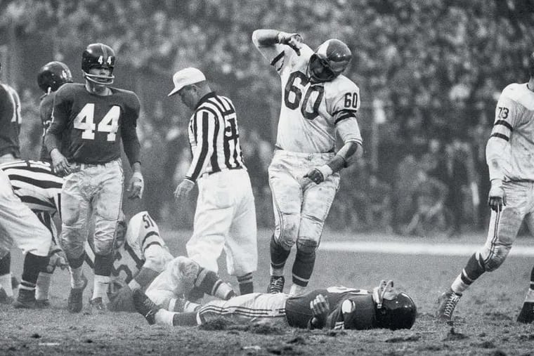 The Eagles' Chuck Bednarik looms over Frank Gifford in an iconic image taken by Sports Illustrated's John G. Zimmerman on Nov. 20, 1960. Bednarik long said he was just exulting over a fumble that secured an Eagles victory in New York. Another Zimmerman photo has come to light, and it may change the way football fans think of that brutal play.