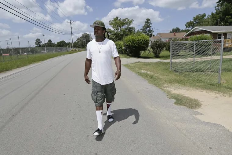 Charles Ben walks along Liberty St. from his grandmothers house to his fathers in St. Matthews, South Carolina on August 18, 2017. Charles Ben was a two sport standout at Calhoun County High School. His brother is Eagles wide receiver Alshon Jeffery.