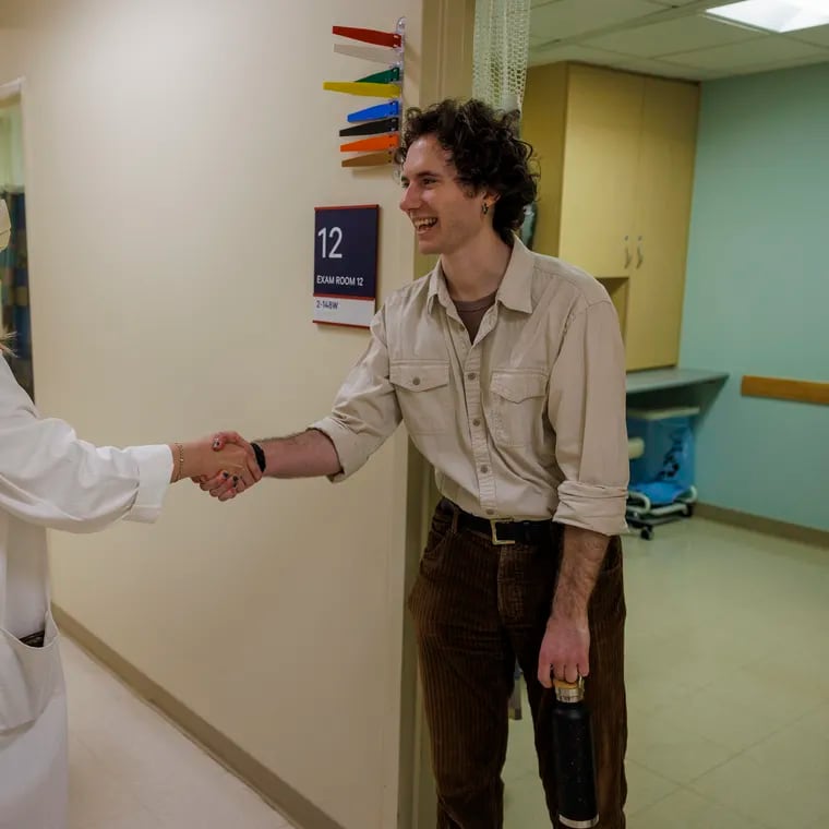 A kidney donor (right) greets a kidney transplant physician assistant ahead of their operation. A national debate asks whether kidney donations should be purely altruistic, or if donors could benefit via tax credits.