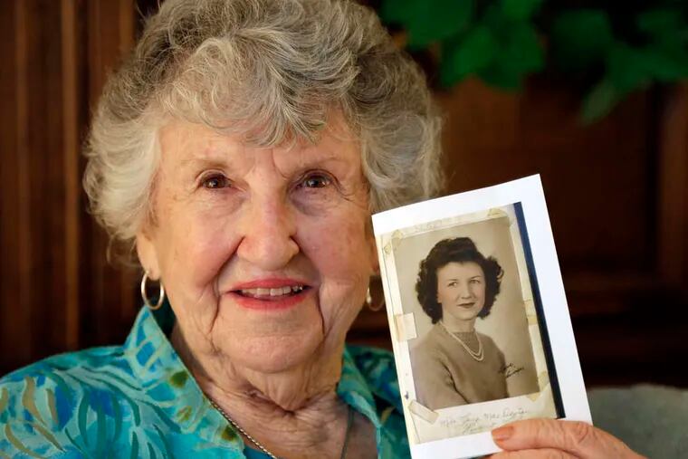 Laura Mae Davis Burlingame, 90, holds a high school photo of herself. The picture filled the back cover of a diary she had given to a Marine who died on Peleliu.