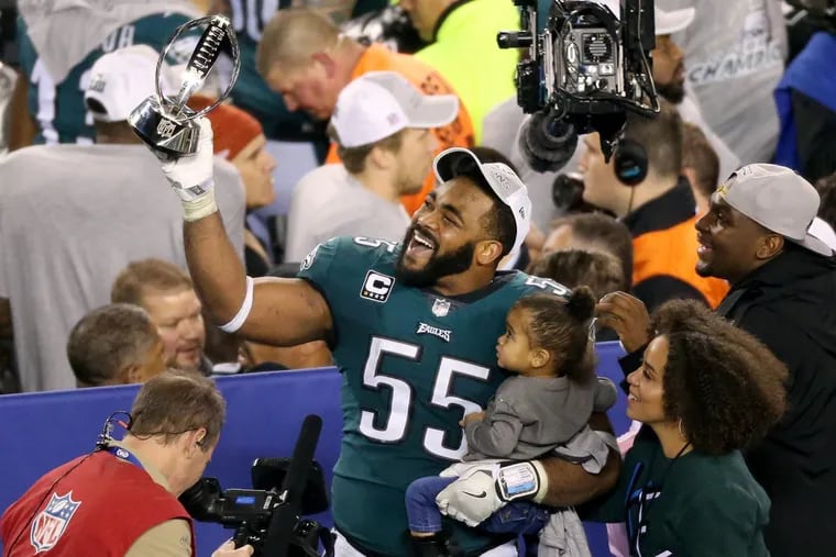 Eagles defensive end Brandon Graham celebrates with the trophy after the NFC championship game at Lincoln Financial Field on Sunday, Jan. 21, 2018. The Eagles won 38-7.