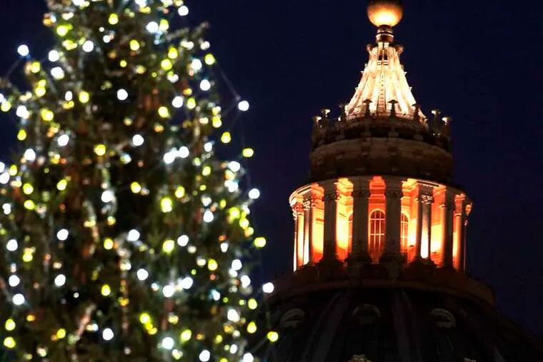 St. Peter's Basilica is framed by the 82-foot Christmas tree lit up at the Vatican on Friday. Ukraine supplied the tree.
