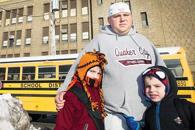 David Brass and sons Justin, 9 and Cody, 5 (right) in front of the Edwin Forrest Elementary School at 7300 Cottage in northeast Philadelphia. Photograph taken on Thursday morning February 20, 2014. ( ALEJANDRO A. ALVAREZ / STAFF PHOTOGRAPHER )