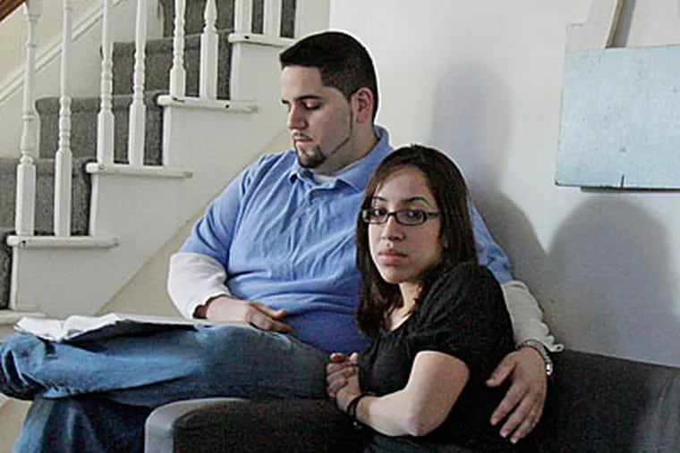 Gisell Andrea Torres and husband Yoniel Lopez in the living room of their New Brunswick home on January 29, 2009. ( Elizabeth Robertson /Staff Photographer )
