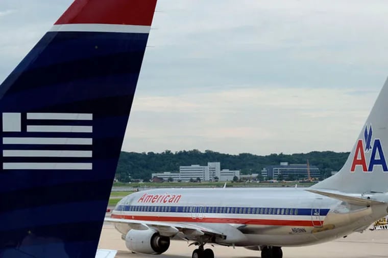A planned merging of American Airlines and US Airways could be a boon for Philadelphia but might cost jobs in Pittsburgh. Where does a top state official stand? (Susan Walsh / AP)