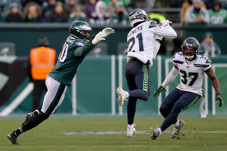 Seattle Seahawks cornerback Tre Flowers intercepts a pass intended for Eagles wide receiver Jordan Matthews on Sunday.