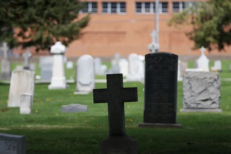 Gravestones are pictured at New Cathedral Cemetery in North Philadelphia on Tuesday, April 14, 2020.