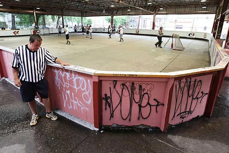 Men's street hockey action at Fishtown Rec Center's concrete rink, which is in serious need of repair.  ( Steven M. Falk / Staff Photographer)